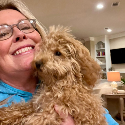 Laura from Paws Sitting Service holding puppy